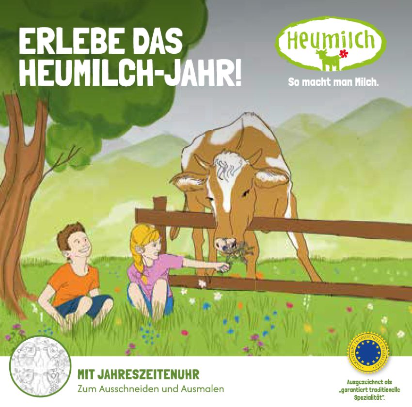 Zwei Kinder sitzen in der Heumilchwiese und füttern eine Kuh