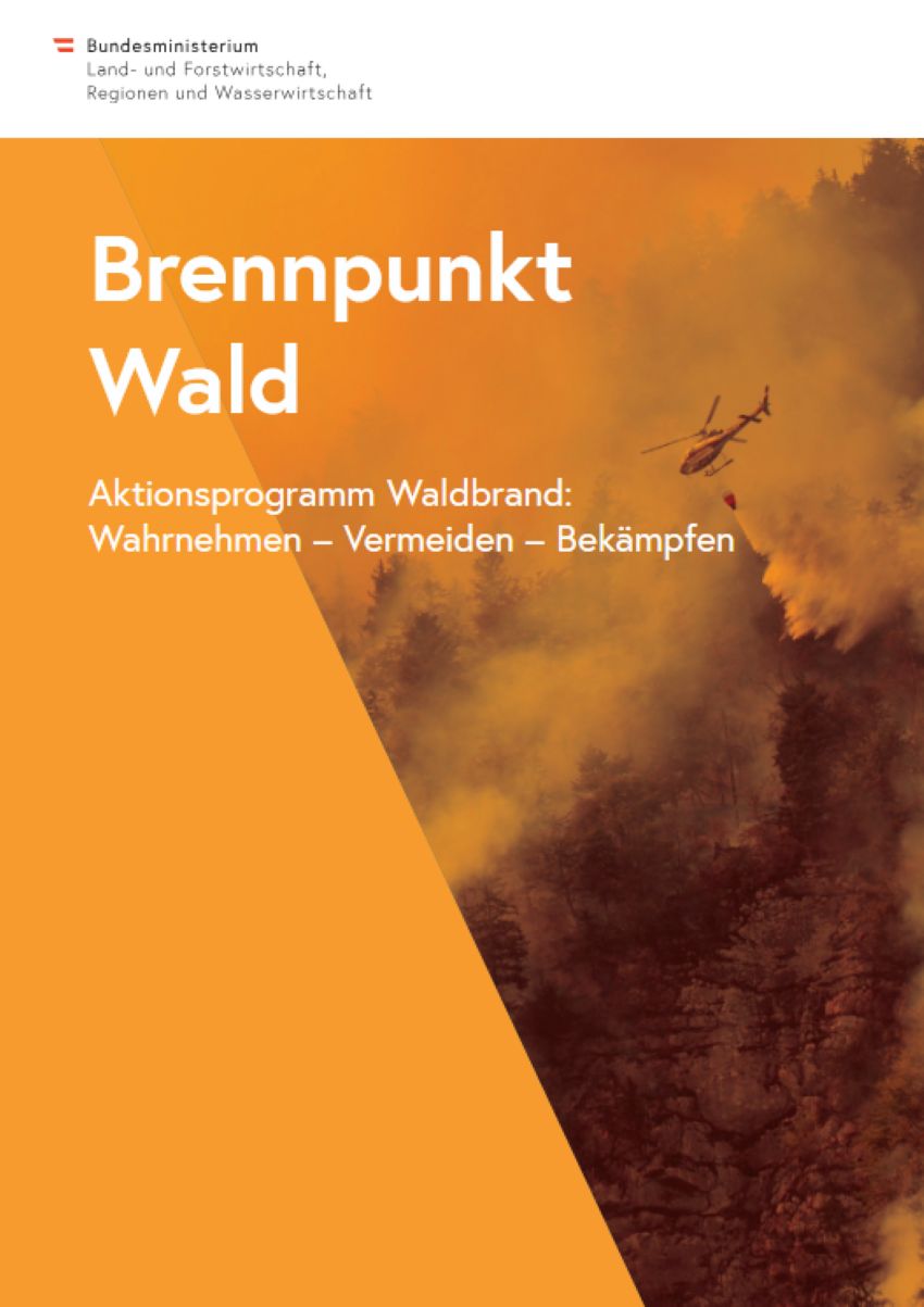 ein Wald der brennt und ein Hubschrauber löscht das Feuer
